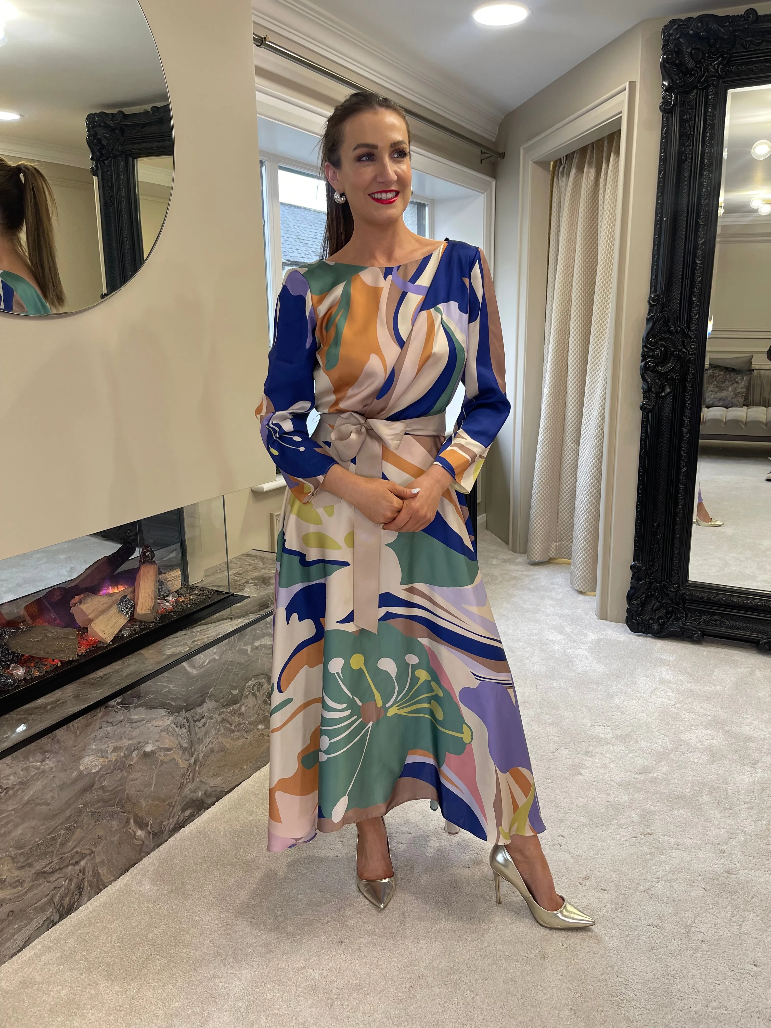 Certainly! An optimized title for the e-commerce product could be:

Elegant Matilde Cano Dress 2201ML - Purple & Green Color Block Gown

This title includes descriptive modifiers that help convey key features of the product, which can attract potential buyers and improve searchability.